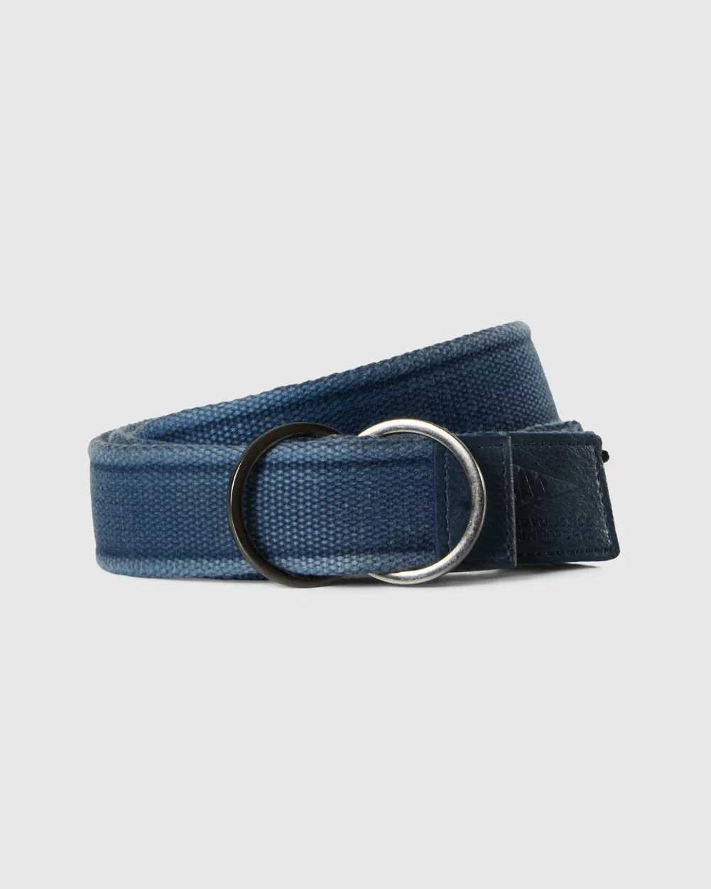 Ceinture Les Voiles 26 in deep navy coiled flat: double D-ring buckle and an end tab stamped with the Les Voiles de Saint-Tropez logo.